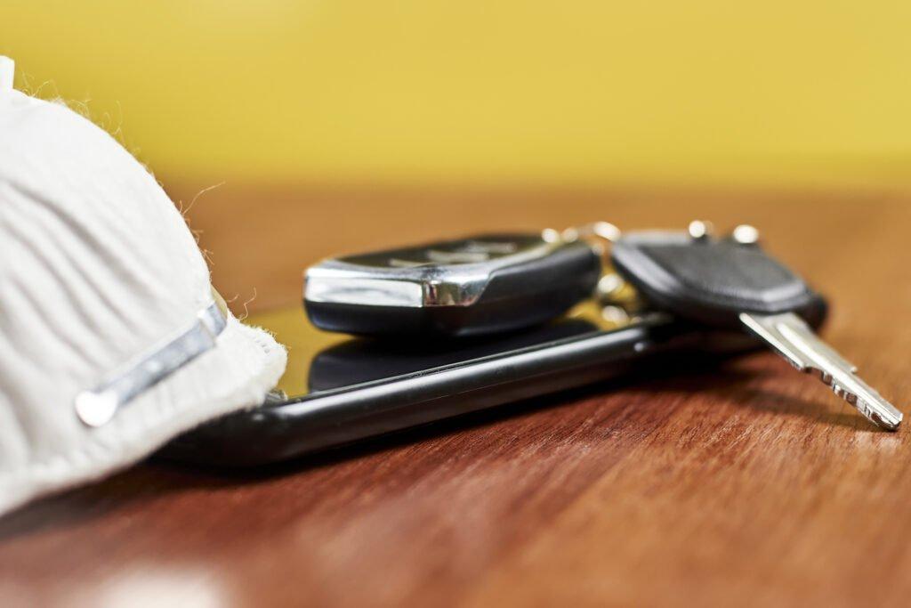 Car keys, smartphone and n95 face mask respirator